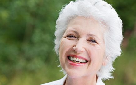 Smiling elderly woman with red lipstick